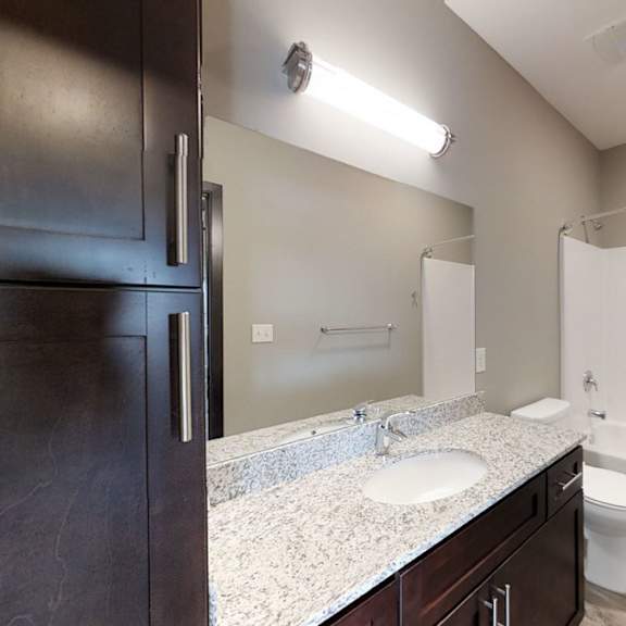 Thumbnail 10 of 10 A bathroom with a sink, toilet, and bathtub.
