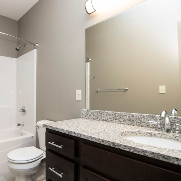 Thumbnail 13 of 14 A white toilet sits next to a sink in a bathroom.
