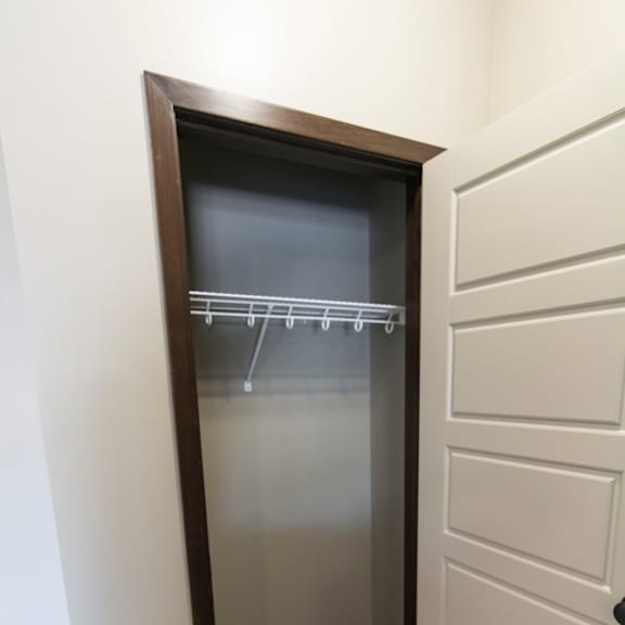Thumbnail 3 of 14 A white door with a black frame is open to a hallway.