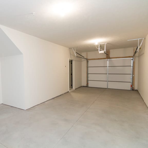 Thumbnail 14 of 14 A large empty room with a white ceiling and a door on the right side.
