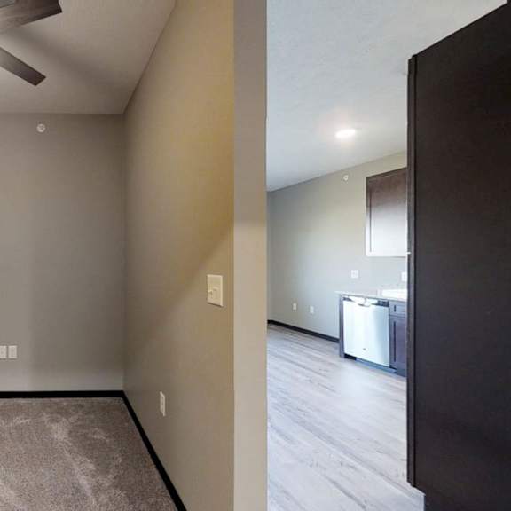 Thumbnail 6 of 10 a bedroom with a ceiling fan and a carpeted floor