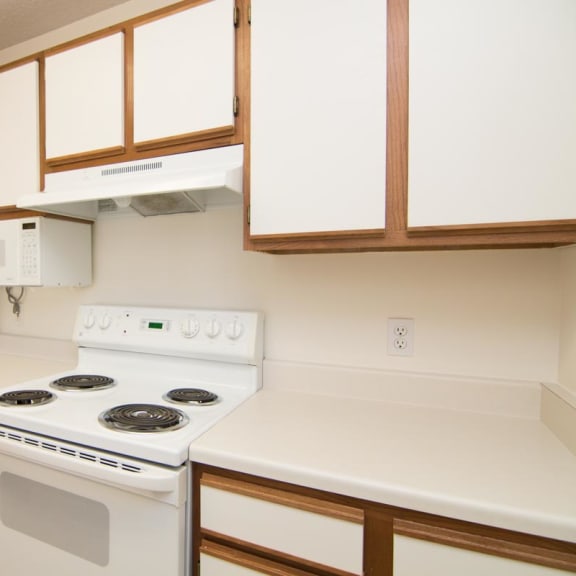 Thumbnail 4 of 15 a kitchen with a stove and a refrigerator