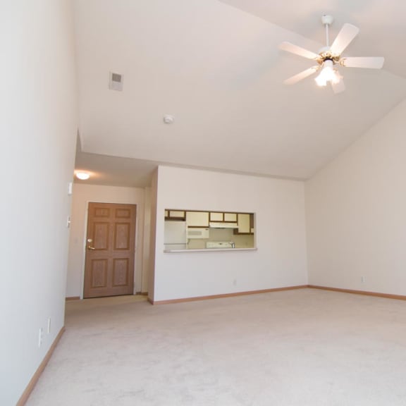 Thumbnail 8 of 15 an empty living room with a ceiling fan