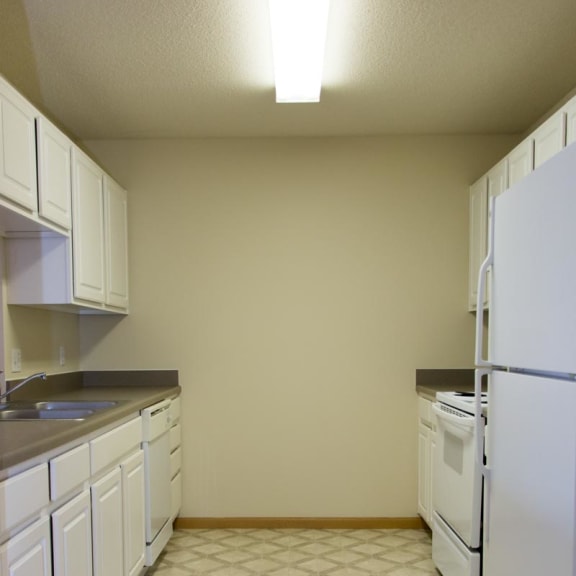 Thumbnail 2 of 13 a kitchen with white cabinets and a white refrigerator