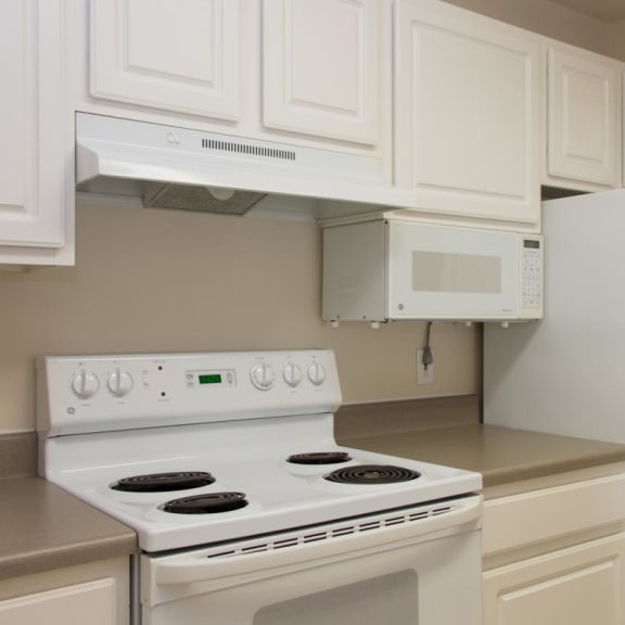 Thumbnail 3 of 13 a kitchen with white appliances and white cabinets