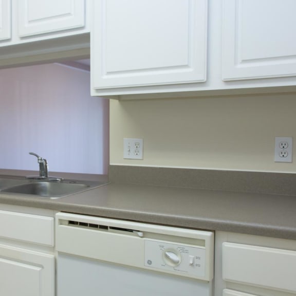 Thumbnail 4 of 13 a kitchen with white cabinets and a sink and a dishwasher