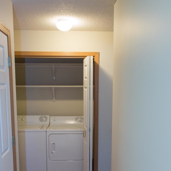 Thumbnail 9 of 13 a laundry room with a washer and dryer in it