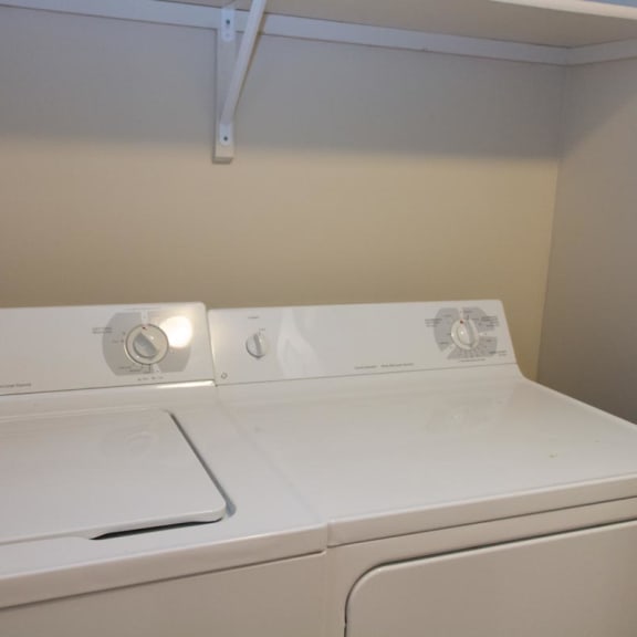 Thumbnail 10 of 13 a white washer and dryer in an empty laundry room