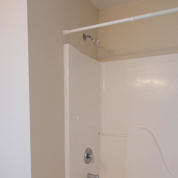 Thumbnail 13 of 13 a white bath tub in a bathroom with a shower curtain