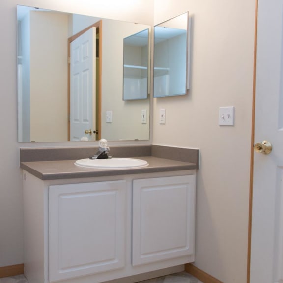 Thumbnail 12 of 13 a bathroom with a toilet and a sink and a mirror