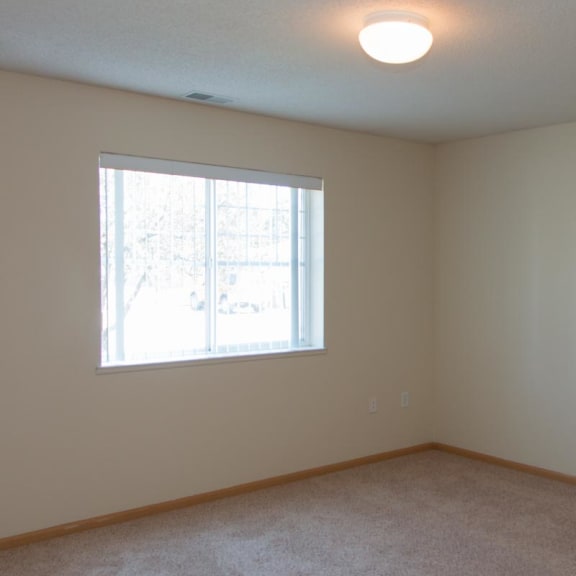 Thumbnail 8 of 13 a bedroom with a window and a carpeted floor