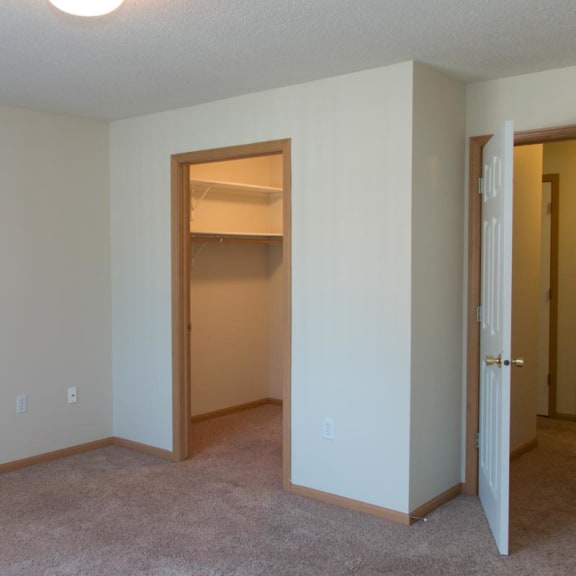 Thumbnail 11 of 13 an empty living room with an open door to a closet
