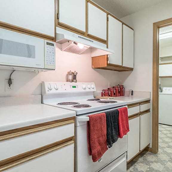 Thumbnail 3 of 14 Kitchen with lots of storage and attached laundry room at The Northbrook Apartment Homes, Lincoln, NE