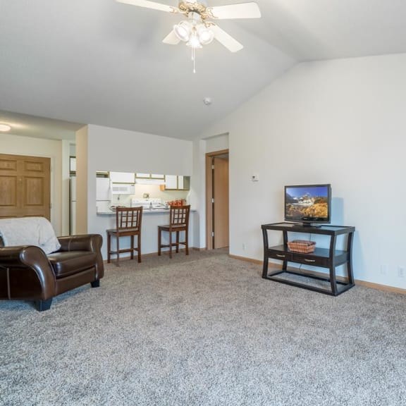 Thumbnail 6 of 14 a living room with a fireplace and a couch