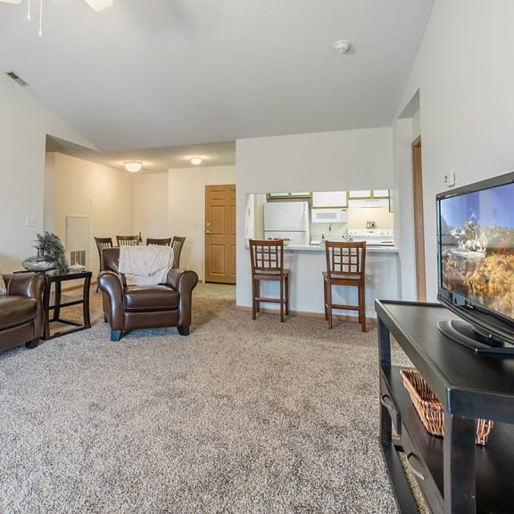 Thumbnail 7 of 14 a living room with a couch and a tv