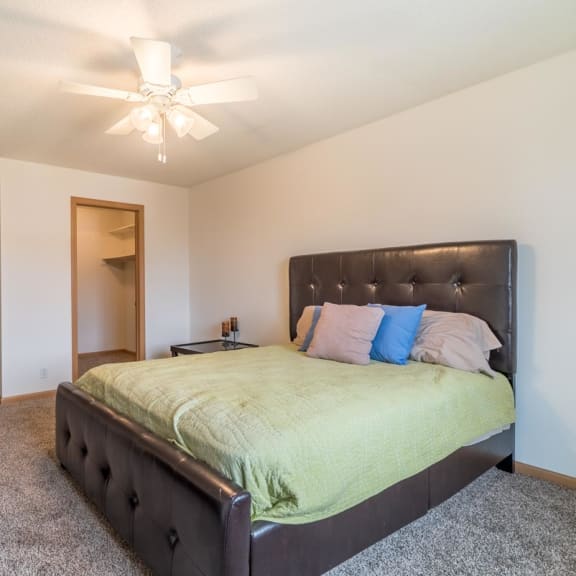 Thumbnail 9 of 14 a bedroom with a large bed and a ceiling fan