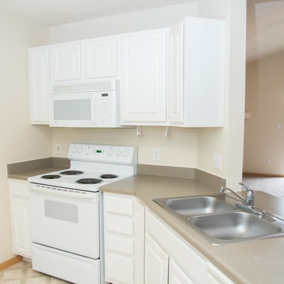 Thumbnail 5 of 21 a kitchen with white appliances and white cabinets