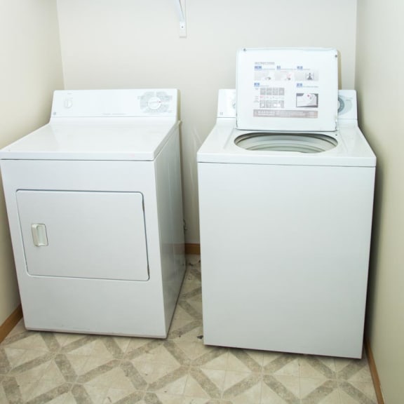 Thumbnail 20 of 21 a washer and dryer in a laundry room with a shelf above it