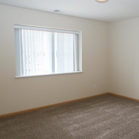 Thumbnail 13 of 21 an empty room with a window and carpet
