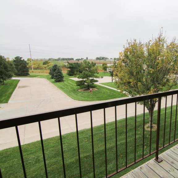 Thumbnail 27 of 27 a view of a yard from the balcony of a house