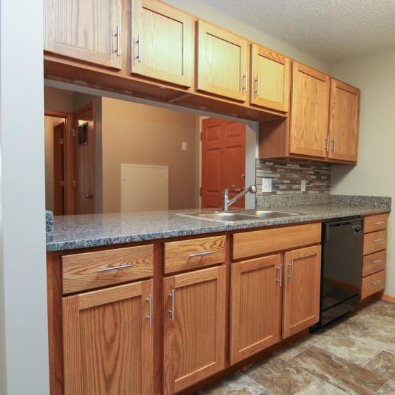 Thumbnail 6 of 27 a kitchen with a counter top and a sink