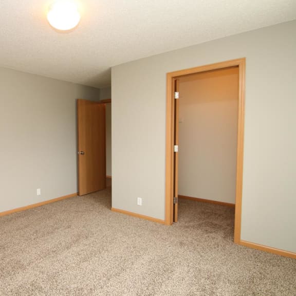Thumbnail 13 of 27 a empty room with a door to a closet