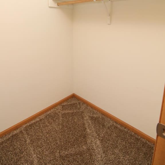 Thumbnail 14 of 27 a small room with a white wall and a shelf
