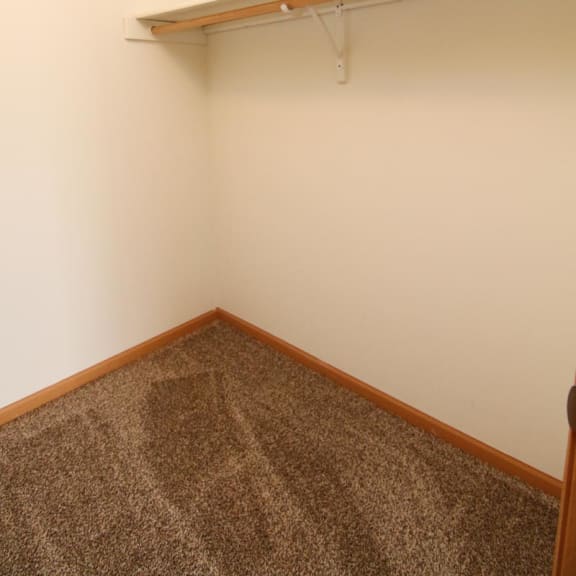 Thumbnail 21 of 27 a room with a carpeted floor and a shelf on the wall