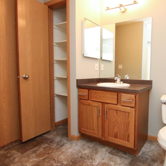 Thumbnail 16 of 27 a bathroom with a toilet and a sink and a mirror