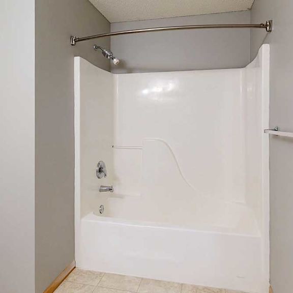 Thumbnail 27 of 29 a white bathroom with a tub/shower combo