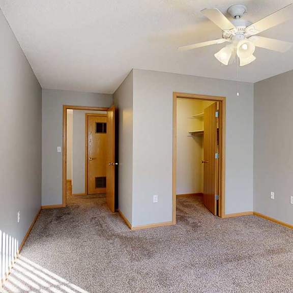 Thumbnail 10 of 29 bedroom room with a ceiling fan and walk in closet