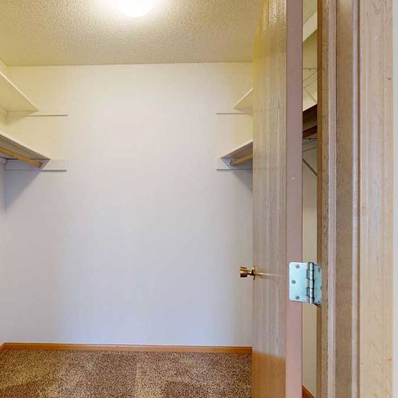 Thumbnail 25 of 29 large walk-in closet with storagee walls.
