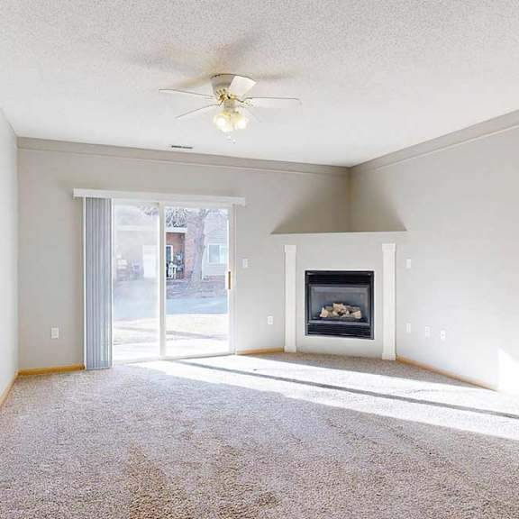 Thumbnail 18 of 29 a living room with a fireplace and a ceiling fan