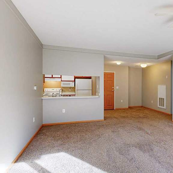 Thumbnail 15 of 29 a spacious living room with a ceiling fan and carpeted floor