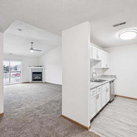 Thumbnail 27 of 29 A kitchen with white cabinets and a refrigerator.