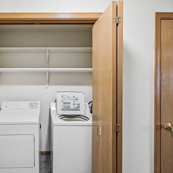 Thumbnail 22 of 29 A small laundry room with a washer and dryer.