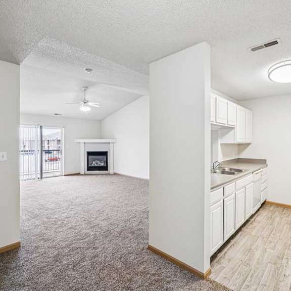 Thumbnail 18 of 28 A spacious kitchen with white cabinets and a refrigerator.
