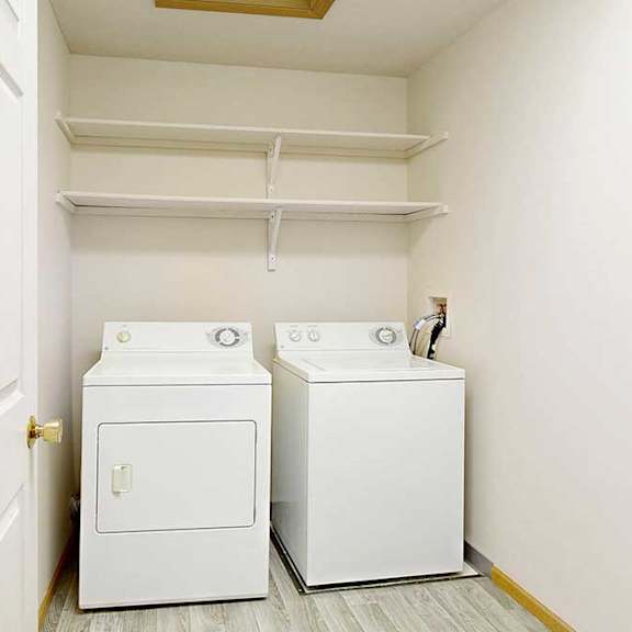 Thumbnail 13 of 31 a laundry area with full-size washer and dryer under shelves