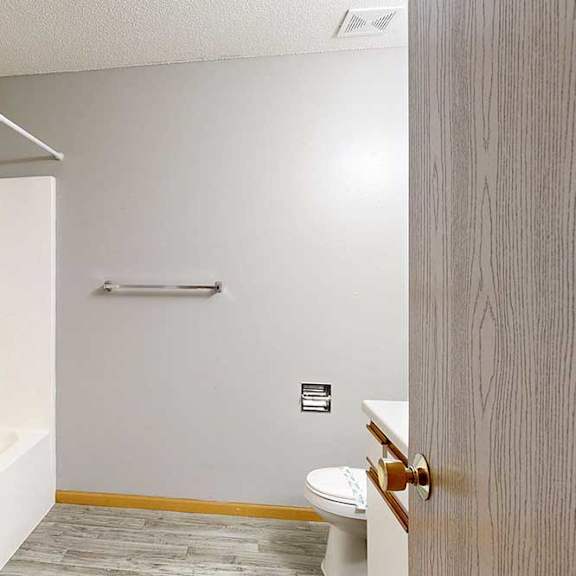 Thumbnail 28 of 61 bathroom with a toilet and a towel rack.