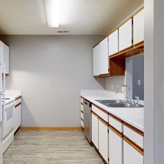 Thumbnail 25 of 27 galley-style kitchen with a white appliances and white cabinets.