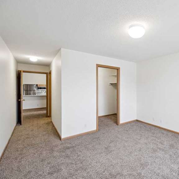 Thumbnail 49 of 61 A room with white walls and carpeted floor.