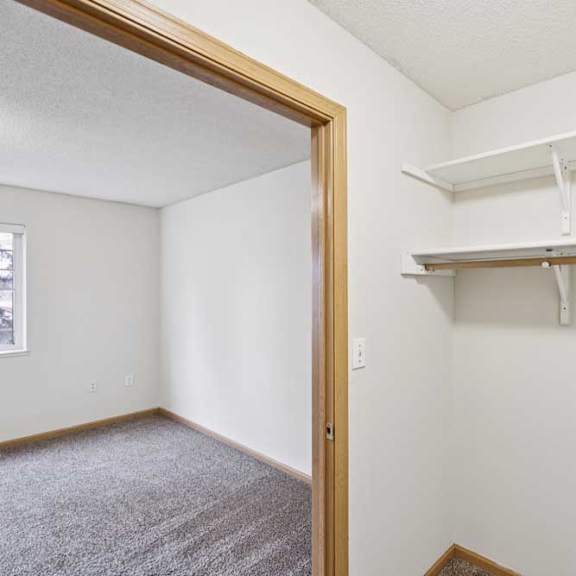 Thumbnail 46 of 56 A white wall with a shelf and a doorway.