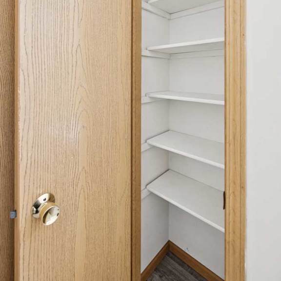 Thumbnail 41 of 56 A wooden door with a handle and a shelf inside.
