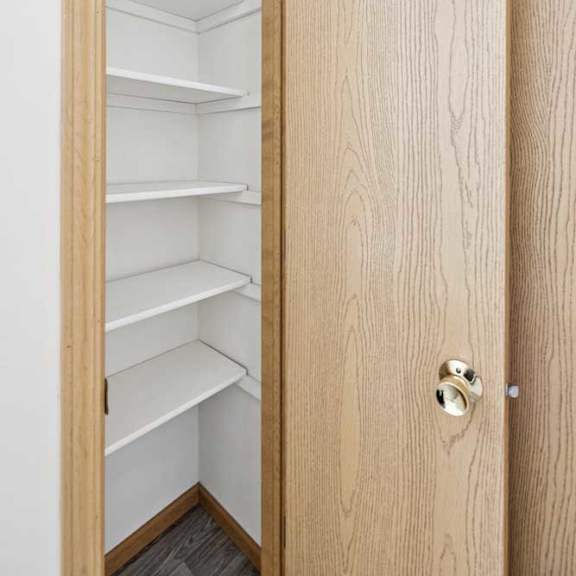 Thumbnail 39 of 56 A wooden door with a handle and shelves inside.