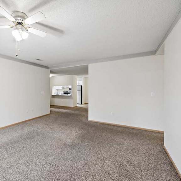 Thumbnail 54 of 56 A room with a ceiling fan and carpeted floor.