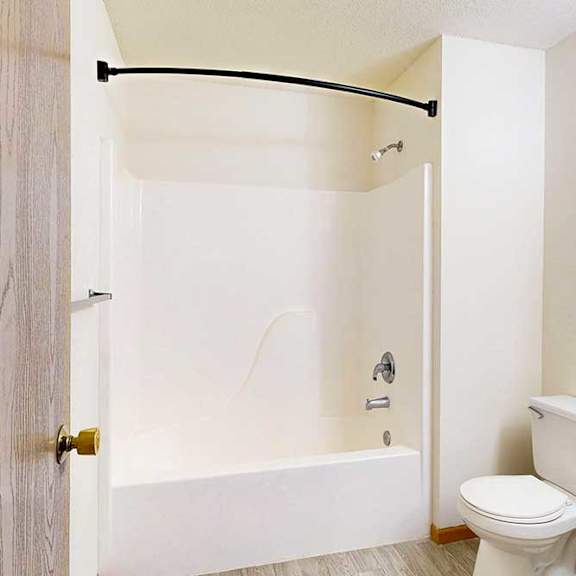 Thumbnail 26 of 29 a bathroom with white cabinets, a combination shower and tub, and a black curved curtain rod
