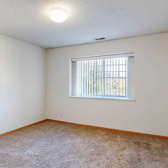 Thumbnail 28 of 29 a carpeted bedroom with a large window with blinds