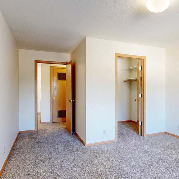 Thumbnail 27 of 29 a carpeted bedroom with a walk-in closet