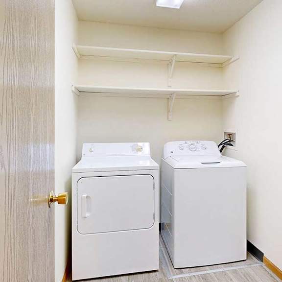 Thumbnail 19 of 29 a laundry room with a full-sized washer and dryer and built-in storage shelving
