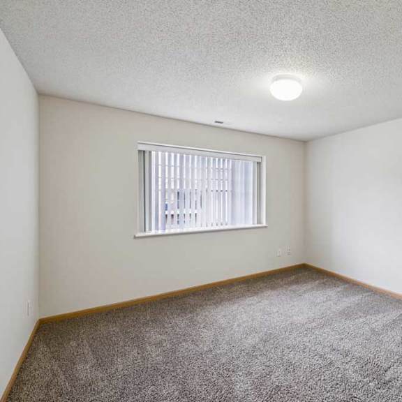 Thumbnail 31 of 48 A room with a window and carpeted floor.